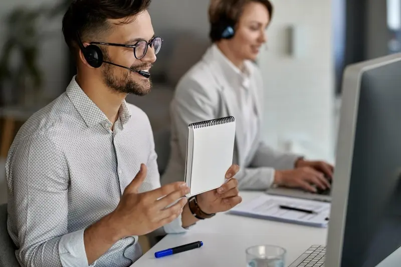 happy customer service representative using computer having video call with clients while working call center